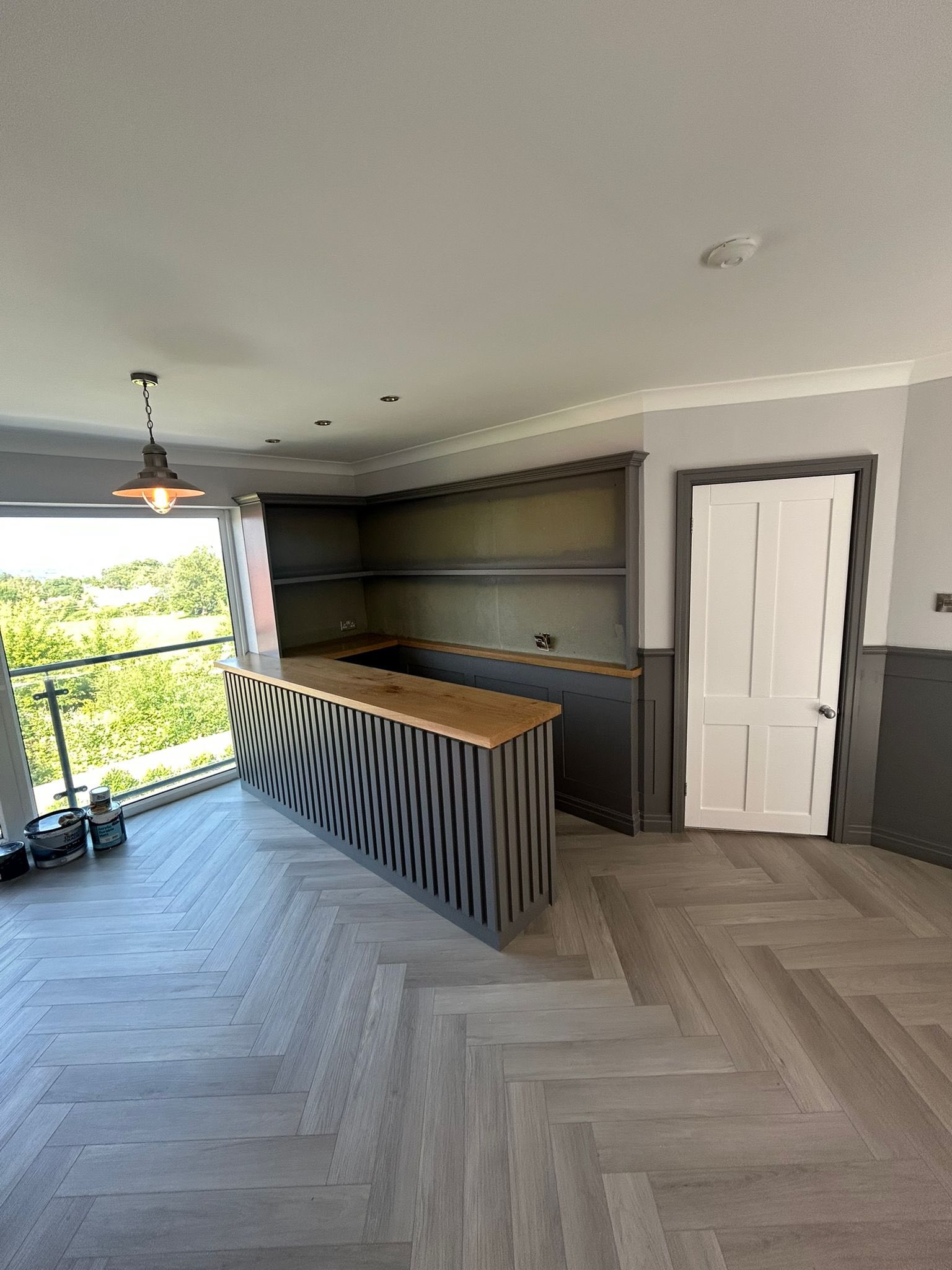 Domestic kitchen with dark grey shaker units freshly decorated