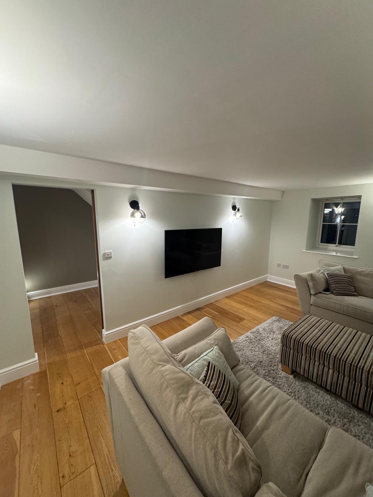Domestic living room with fresh cream walls and oak flooring